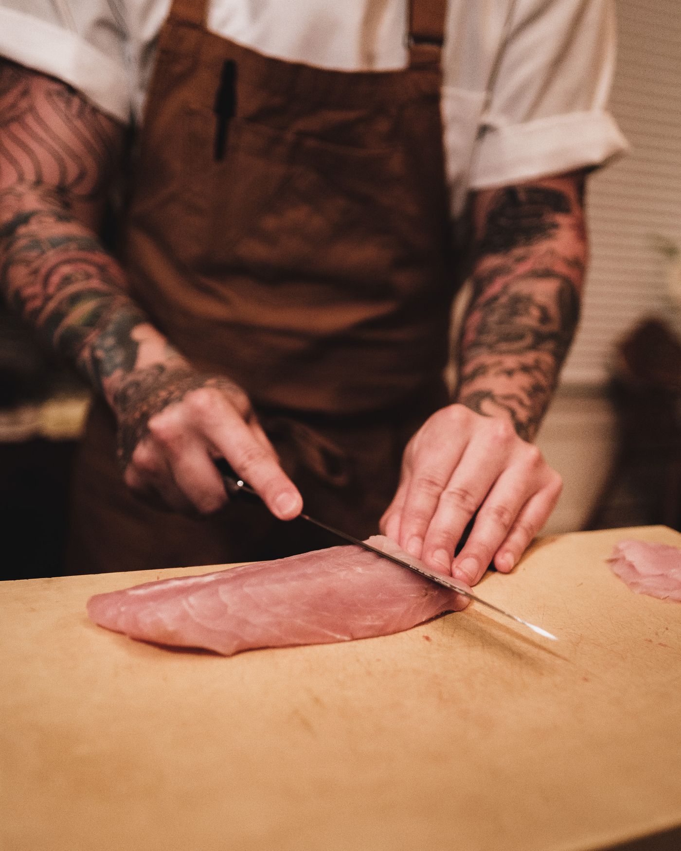 Butcher slicing meat