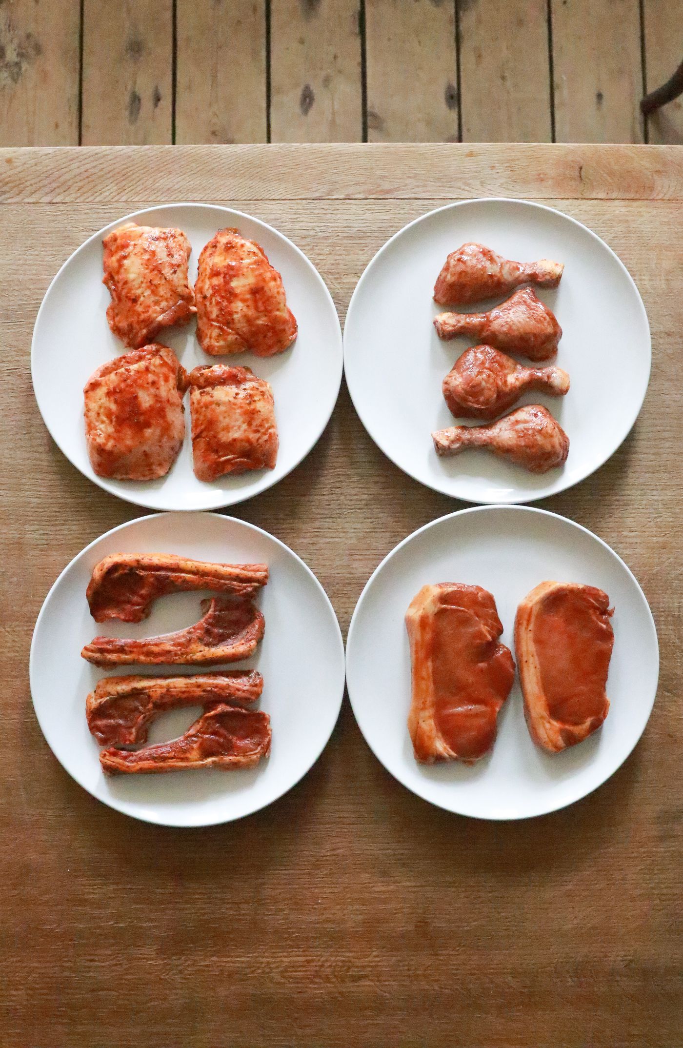Assorted raw cuts of meat on plates