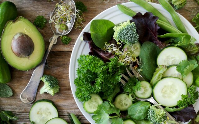 A low-carb plate with broccoli, cucumber, and avocado, representing the low-carb diet